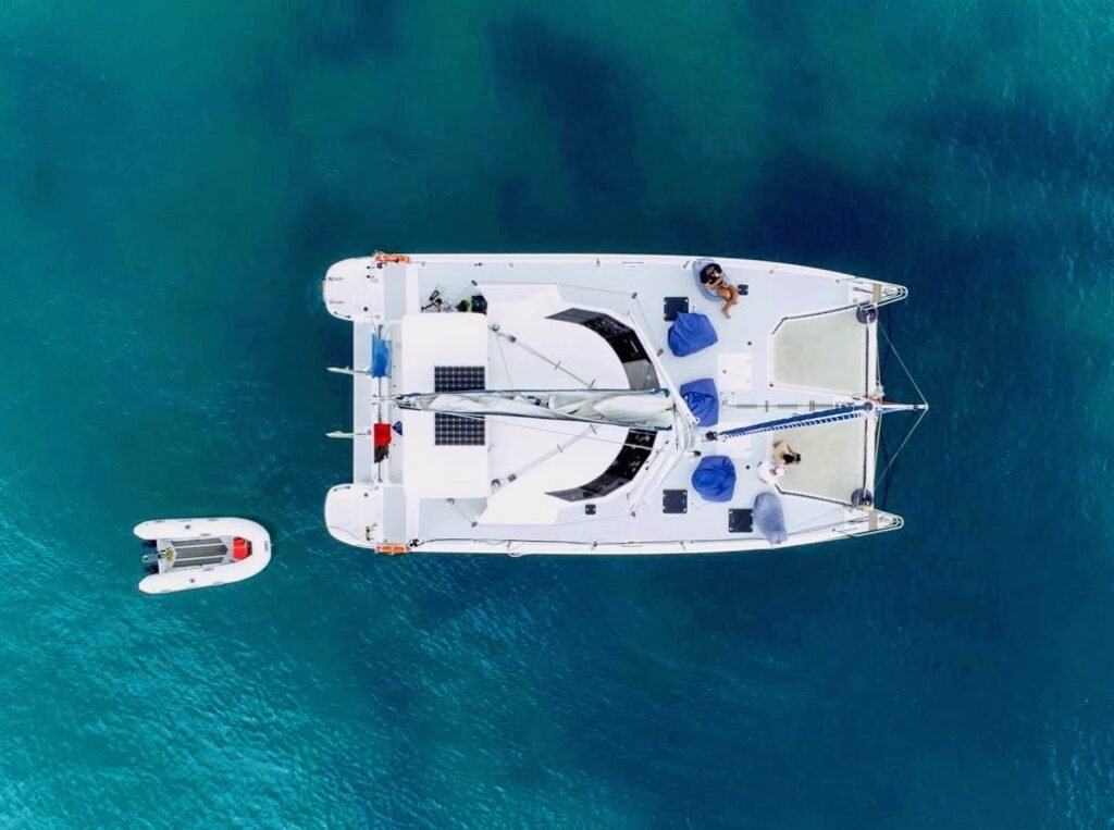 Aerial view of the Bayscapes Sailing Charters catamaran Hibiscus Star sailing in the Bay of Islands