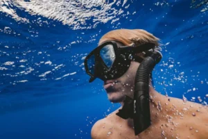 Guests snorkelling in clear turquoise water during a sailing charter in Bay of Islands