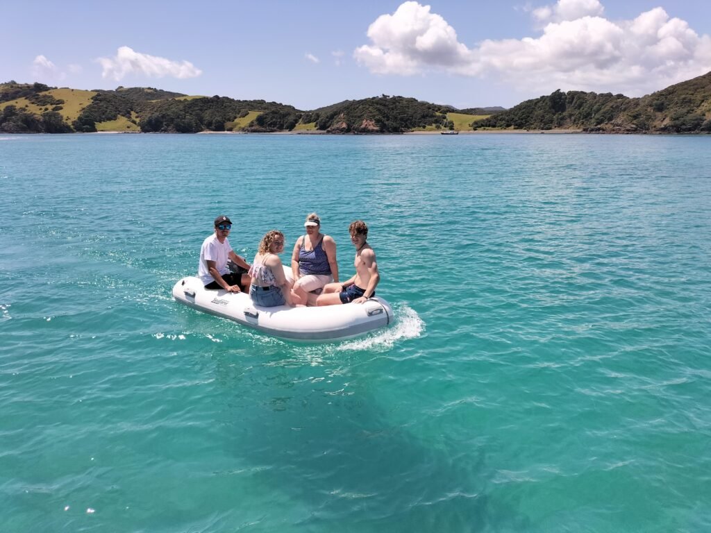 Guests taking a tender ride ashore on a Bay of Islands day sailing trip