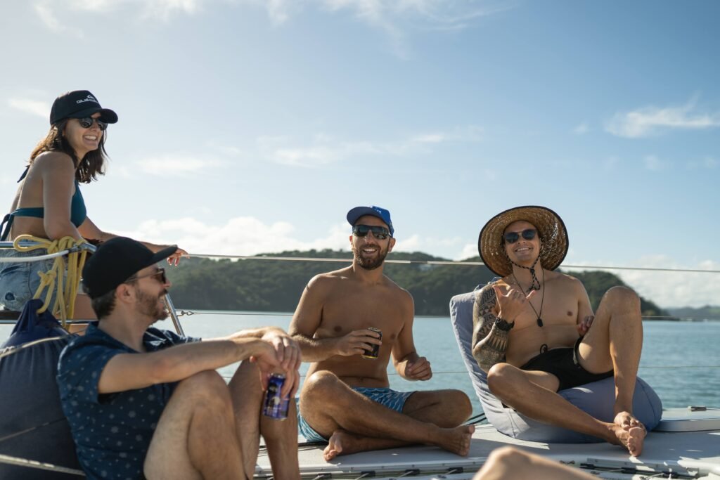 Guests Relaxing on beanbags and the deck of a sailing catamaran in the Bay of Islands